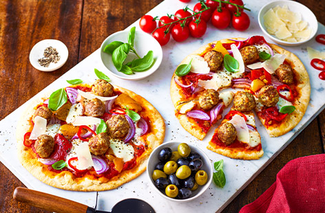 Top shop-bought pizza bases with a fiery tomato sauce and homemade meatballs for a speedy supper that's ready in just 35 minutes