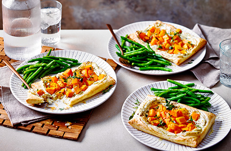 Bake these easy mini butternut squash and sweet potato tarts for a simple vegetarian dinner idea. Peppery cream cheese makes an quick base on top of buttery pastry, topped with herby roasted veg.
