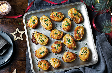 These mini rarebit potatoes are the ultimate indulgent Christmas party food. Crispy roast potatoes are topped with a melting cheese sauce and grilled until bubbling for a comfort food veggie canapé.