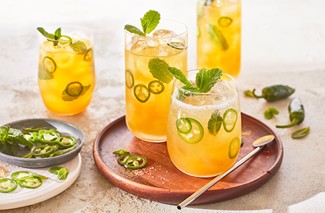 Treat yourself to a refreshing mojito, spiked with hot jalapeños and amped up with a tropical twist of mango juice. Muddled together with ice, sugar, mint and soda water for the ultimate summer's night cocktail.