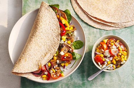 Wholemeal tortillas are stuffed full with smoky mushrooms and peppers. Serve with a charred sweetcorn salsa for a flavourful dinner that's on the table in just 25 minutes.