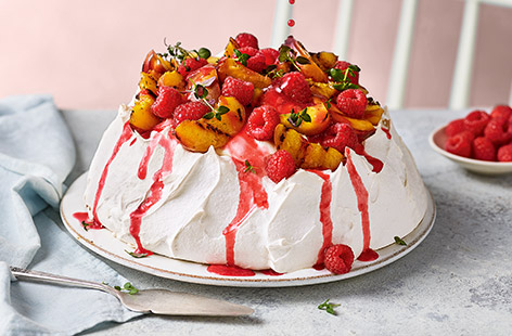 Marrying two all-time favourite desserts – peach melba and pavlova, is this stunning showstopper of a dessert. It's gluten-free and serves 12, so it's perfect for summer entertaining when peaches are in season.