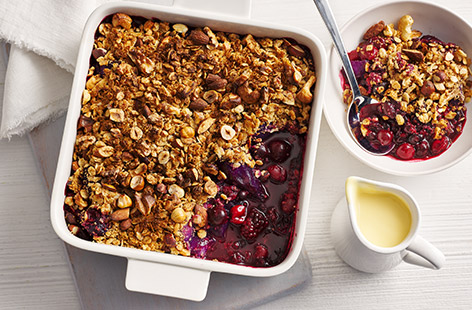 Tinned and frozen fruit make this reduced-sugar crumble more affordable. Enjoy on its own or with cream or ice cream.