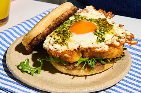 This pesto crispy feta egg sausage muffin is what Sunday brunch dreams are made of! Finished with our cheat code, hot honey, this café-style brekkie is the ultimate weekend treat!