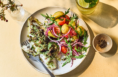 Baked fish makes such a lovely quick dinner – it's easier than you think to cook too, you just need to pack in the flavour when using white fish fillets. Step in our punchy seed and courgette pesto that creates a tasty and crunchy topping. Serve with a dressed salad of potatoes, tomatoes and rocket for a light and healthy summery meal.