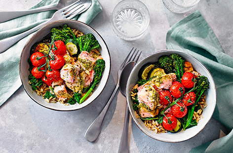 Packed with fresh flavours, this vibrant rice bowl is an easy recipe for two - serve warm for dinner, or save leftovers for lunch the next day if cooking for one. Pesto-baked salmon joins Tenderstem broccoli, courgette, sweet cherry tomatoes and steamed curly kale. 