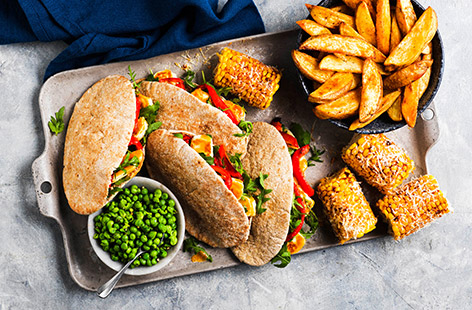 Squeeze in extra veg and dial up the flavour with our veggie twist on this restaurant favourite. Piri-piri coated-halloumi is stuffed into warm pitta breads and served with epic sides you will devour.