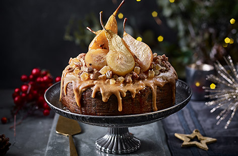 Poached pears add a delicate sweetness to this simple homemade Christmas cake