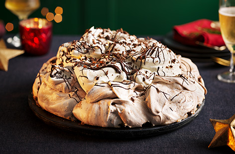 This mocha pavlova will be the star of your Christmas table. An espresso swirled meringue is topped with whipped cream and melted dark chocolate.