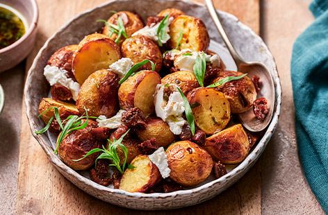 These sweet and salty roasties are sure to wow any guests. The combination of soft goat's cheese and sweet figs makes for a perfectly rounded side. Top that off with a zingy, herby dressing and you've got a delicious spring dish to pep up any roast dinner. 