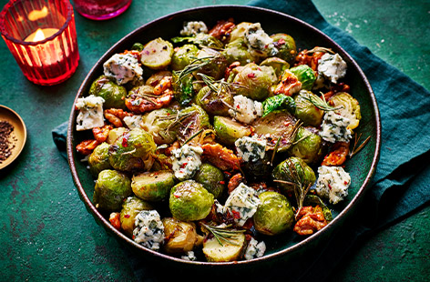 Take your sprouts to the next level by roasting them in honey, chillies and walnuts for a sweet, spicy and earthy crunch. A crumble of tangy blue cheese on top and you've got an epic side dish for Christmas lunch.