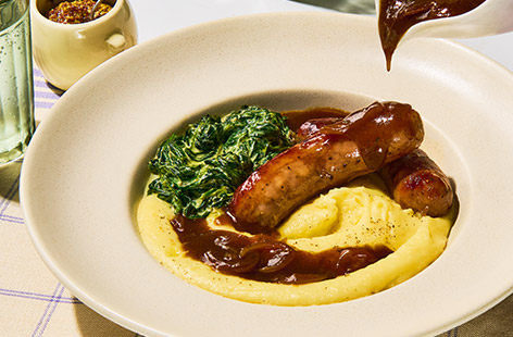 Bangers and mash get elevated in this French-inspired dish. Aligot is a rich buttery mash potato enriched with cheese. It’s indulgent and delicious. We like to serve it with onion gravy and creamed spinach for a 10 out of 10 comforting dinner.