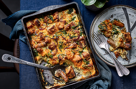 Use up old bread with this simple midweek meal that combines pork chipolatas, red onion, spinach and crusty white slices in a cheesy egg mixture, flavoured with fresh chopped chives.