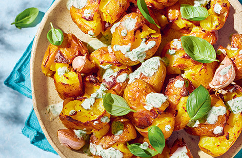We love these moreish smash-and-grab roast potatoes with a herby garlic dip – just right for a sharing platter.