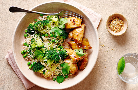Succulent chicken thighs are coated in a sticky soy and honey sauce. Serve with green rice, made from broccoli, peas and coriander and a sprinkle of sesame seeds. Don't forget to use the leftovers to make our fast and fresh Nutty chicken noodle salad.