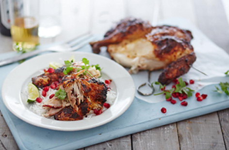 Want to cook a whole chicken on the BBQ? Spatchcocking it will help it cook quickly and evenly, keeping it tender but with delicious smoky charred skin. We’ve given it a Middle Eastern-style twist with spiced yogurt and pomegranate seeds.