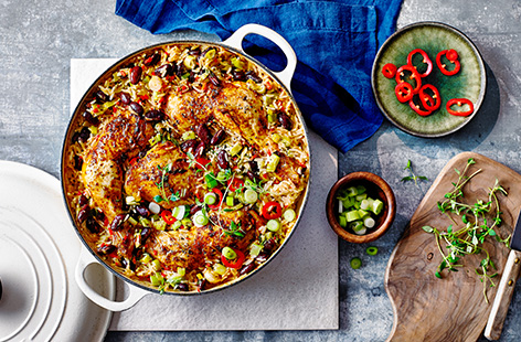 Let the oven do the work with this spicy chicken, rice and peas bake recipe. Tender chicken legs roast alongside fluffy coconut spiced rice and black beans for a colourful one-pot recipe.