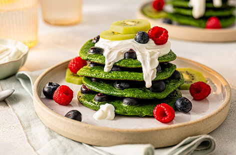 Start your day off the best way possible with these feel-good green pancakes. Spinach is secretly blended into your pancake mix with a dash of honey for extra sweetness. Stack them up high with a dollop of Greek yogurt and some blueberries for good measure.