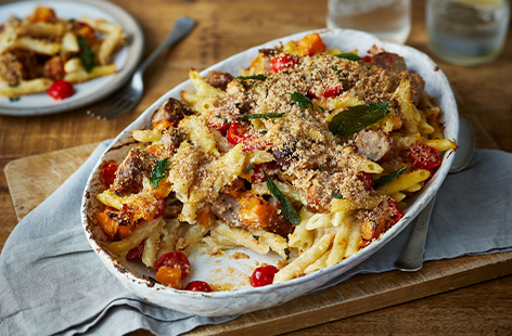 Combine seasonal squash with juicy pork sausages and  fragrant sage for a creamy, indulgent pasta bake fit for a midweek meal