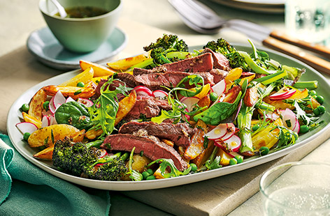 Steak and chips, but not as you know it. Featuring baked herby potatoes and purple sprouting broccoli along with peas, leaves and radishes, this is a nutritious twist on a dine-at-home favourite.