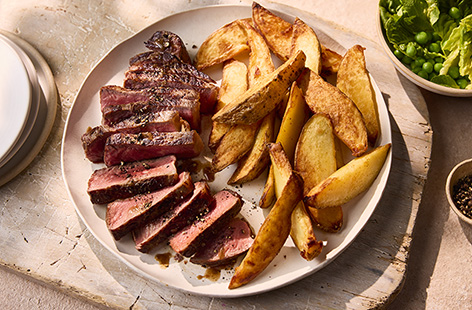 You can't beat a good steak and chips – perfect for a midweek treat or a Friday night feast. No pro cooking skills required for this dish either, just make sure your pan is nice and hot before adding the steak and let it rest after cooking. Serve with spiced potato wedges and minty peas – fantastic!