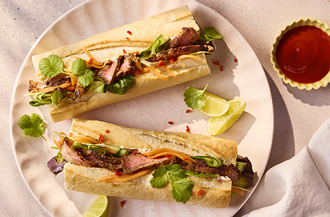 Bánh mì is a delicious Vietnamese baguette sandwich, stuffed with quick-pickled veg and juicy chunks of meat. Start by making the pickles: mix the carrot, spring onion and cucumber with sugar, vinegar and fish sauce. Next, grill the meat after rubbing it in delicious spices. This could fast become your new favourite lunch!