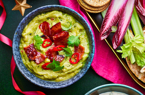 Take party dips to a whole new level with this readymade guacamole and smoky, sweet and spicy bacon topping. Finish with coriander leaves and fine red chilli slices, if you like, and serve with tortilla chips, crudités or whatever takes your fancy. Dip in!