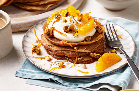 These pancakes are made with sweet potatoes to make them extra sweet and thick. We've topped ours with cream cheese, orange segments and walnuts, but you can use whatever you fancy.