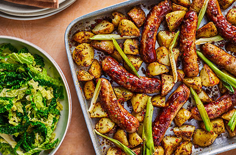 Let the oven do all the hard work with this simple sausage traybake recipe. Glaze sausages in a sticky honey mustard glaze and cook with crispy potatoes and spring onions. Serve with steamed cabbage, if you like.
