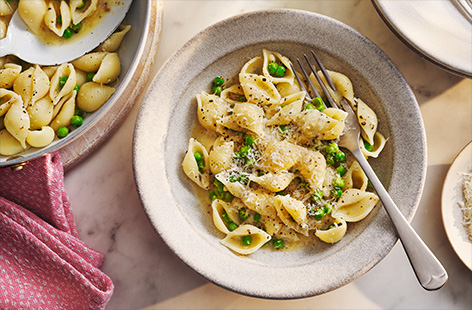 This 5-ingredient pasta is a twist on the popular cacio e pepe dish. The pasta and peas are coated in a cheesy, glossy sauce for a speedy dinner you will love.