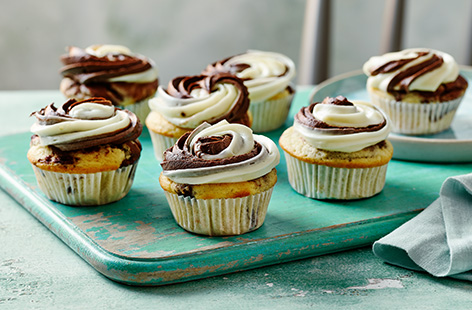 These light 'n' fluffy vegan cupcakes marble vanilla and chocolate sponges together to make a simple yet impressive swirl effect. Topped with a dairy-free cream cheese icing, they're great for a birthday or with a cup of tea.