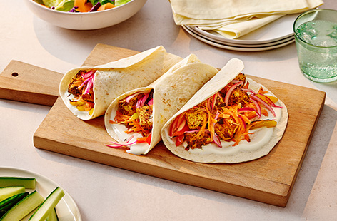 Coat tofu in a gently spiced tikka paste, then fry until golden and crispy. Pile into wraps with crunchy salad and pickled red onions.