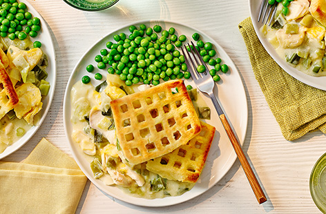 Fish pie gets a family-friendly glow up with smoked fish, leeks and a fun potato waffle topping. Serve with peas for a classic winner dinner.