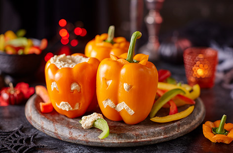 Create a simple and fun Halloween snack, perfect for both grown-ups and kids, using just three ingredients. Cut out fun pumpkin faces in orange peppers, fill with shop-bought hummus and dunk in extra pepper strips and tortilla chips.
