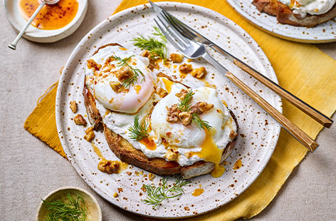 Transport yourself to sunnier climes with this Turkish-inspired poached eggs recipe that's simple to prepare, yet makes for a really special brunch for the weekend or when you're having friends over. Creamy Greek yogurt, crunchy walnuts and a home-infused chilli oil really take this dish to the next level.
