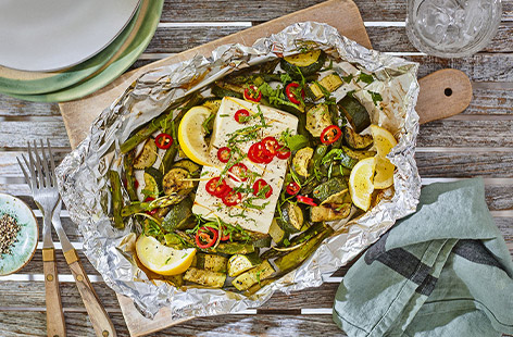 Wrap 'n' roll with this epic parcel that's packed with marinated spring veg and a block of reduced-fat salad cheese, then baked on the barbecue for a fabulously easy veggie main. Give it a go!