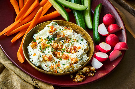 Blitz up this easy-prep dip for an impressive addition to your Christmas party food table. With a garlicky, whipped cheese base and a crunchy, salty-sweet walnut topping, it packs a flavour and texture punch! 