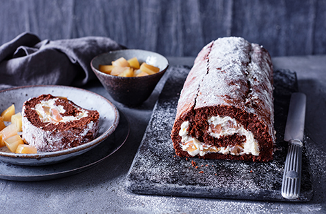Lightly-spiced poached pears and a whipped cream filling are encased in a rich chocolate and whisky sponge for this elegant festive roulade.