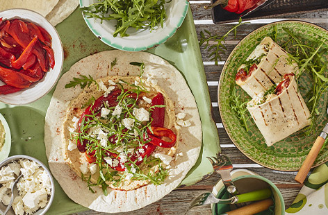 Sizzling smoky peppers are wrapped up in a tortilla with houmous, sweet smoked paprika and salad cheese for an easy veggie barbecue dish