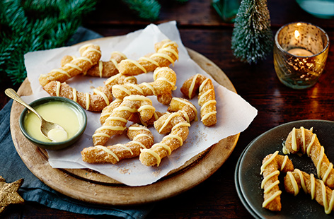Take inspiration from festive Christmas market food with this churros recipe. Shaped into cute candy canes and drizzled with white chocolate for an extra festive twist, they're the perfect pudding for Christmas get-togethers.