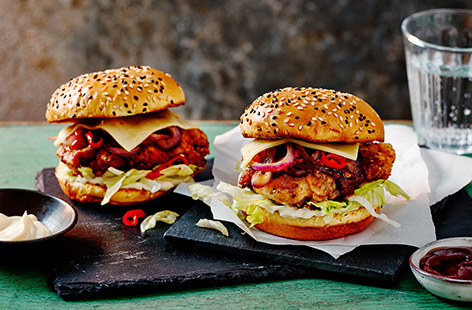 Drums and Flats' buttermilk chicken burger is stacked with onions, chillies, cheese and barbecue sauce all inside a soft pillowy brioche bun.