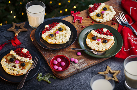 What better way to start Christmas Day than with these cute Santa pancakes topped with a whipped cream beard, pomegranate hat and chocolate nose.