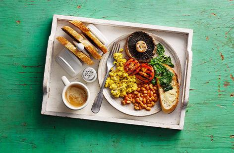 A colourful, vegan take on a classic English breakfast, this quick and healthy meal pairs a simple tofu scramble with grilled tomatoes, mushroom, baked beans and spinach for a vegan fry up