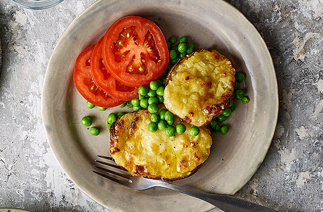 Cheesy stuffed potatoes with tomatoes and peas