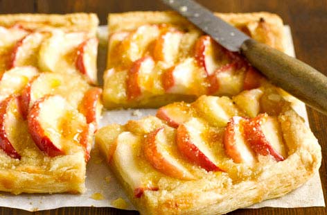 A faff-free apple autumn apple tart with the glorious marzipan scent of almonds, this pudding can be assembled in a flash from ready-to-roll puff pastry. For the best flavour use in season Cox's or Heritage apples and glaze with sweet apricot jam.