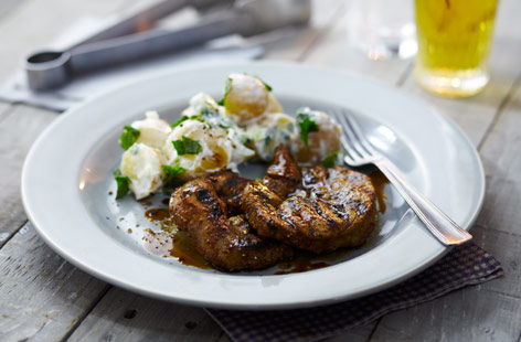 Lamb steaks, marinated with curry powder, ginger, soy sauce, tomato puree and olive oil, then grilled over coals. The accompaniment? That British barbecue staple of potato salad, dressed with yoghurt, mint and finely chopped spring onion.
