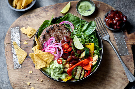 This low carb burger bowl recipe has it all: a succulent beef burger, fresh salad, smokey charred vegetables, homemade guacamole, zingy pickled red onions and crunchy tortilla chips.