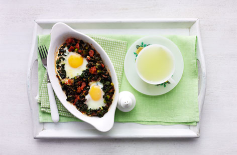 Super mum breakfast in bed: This dish of mildly spiced baked eggs with tomatoes and black kale is the perfect healthy option for a relaxed breakfast in bed and a real treat for a busy mum on Mother's Day