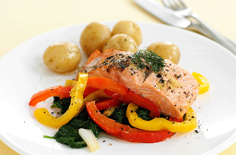 Perfect for those weeknights when you're craving something a little lighter, these individually baked salmon parcels with mixed peppers hit all the right notes. Cook the accompanying spinach any way you like, then finish with a drizzle of olive oil.