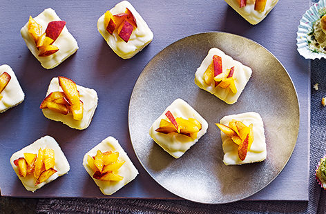 Creamy white chocolate and sweet peach are a heavenly match in these cheesecake cubes. Bite-sized and colourful, they are sure to go down a treat at summer parties